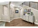 Elegant entryway with hardwood floors, stylish console table, decorative art, and staircase at 6470 Amur Ct, Castle Rock, CO 80108