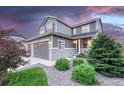 Beautiful two-story home with stone accents, landscaped yard, and attached two-car garage at 6470 Amur Ct, Castle Rock, CO 80108