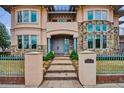 Elegant home entrance featuring stone walkway, manicured landscaping, and a custom address marker at 115 S Jasmine St, Denver, CO 80224
