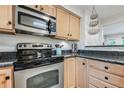 Stainless steel appliances and granite countertops in this kitchen at 601 Cheyenne St # 202, Golden, CO 80403