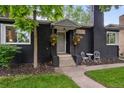 Close-up of home's entrance, showcasing the walkway, front door, and hanging flower baskets at 1218 S University Blvd, Denver, CO 80210