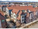 Lovely brick townhome showcasing its stylish exterior, charming balcony, and its convenient location with mountain views at 439 S Reed Ct, Lakewood, CO 80226