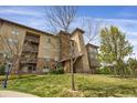 Multi-story condo building with well-maintained lawns and private balconies at 85 Rampart Way # 206, Denver, CO 80230