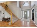 Inviting foyer with hardwood floors, staircase, and a view of the front door at 2460 Switch Grass Way, Castle Rock, CO 80109