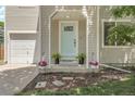 Close-up of the front porch with a light blue door, plants, and well-manicured landscaping at 11757 W Tufts Pl, Morrison, CO 80465