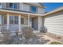Inviting front porch and entryway featuring well-maintained landscaping and stone accents at 5251 Altura St, Denver, CO 80239