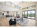 Bright and airy living room with high ceilings, large windows, and access to the kitchen area at 912 Coronado Dr, Sedalia, CO 80135