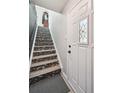 Bright entryway showcases a decorative staircase with patterned treads and a glass paneled door at 1225 S Oneida St # 248, Denver, CO 80224