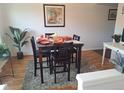 Dining area with a square table, four chairs, and hardwood floors at 7505 W Yale St # 2103, Denver, CO 80227