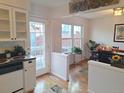 Bright kitchen with white cabinets, stainless steel appliances, and access to a patio at 7505 W Yale St # 2103, Denver, CO 80227