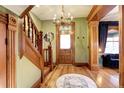 Grand entry with wood staircase, hardwood floors, and a chandelier at 1563 High St, Denver, CO 80218