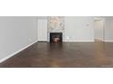 Large living room with fireplace, wood floors, and plenty of natural light at 2366 S Troy St, Aurora, CO 80014