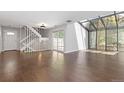 Open living room with wood floors and lots of light coming from the atrium at 2366 S Troy St, Aurora, CO 80014