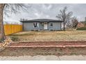 Well-kept single story with a brick facade and tidy front yard, offering a classic, welcoming curb appeal at 9295 E 12Th Ave, Aurora, CO 80010