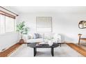 Bright living room with hardwood floors, stylish furniture, and natural light at 822 S Worchester St, Aurora, CO 80012