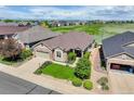 Aerial view of a home with a lush green lawn and mature landscaping adjacent to a golf course at 14879 Xenia St, Thornton, CO 80602