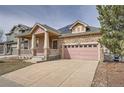 Beautiful home with a two car garage, complemented by stone and siding details at 1260 S Duquesne Cir, Aurora, CO 80018