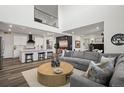 Open-concept living area with a stylish gray sectional, kitchen with breakfast bar, and modern decor at 17121 Desert Wine Ln, Parker, CO 80134