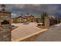 Grand estate home with a large motor court and fountain at 6302 Charrington Dr, Cherry Hills Village, CO 80111