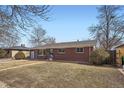Classic brick home with a tidy lawn and mature trees, offering great curb appeal at 3148 Victor St, Aurora, CO 80011