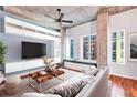 This living room has concrete ceilings, a ceiling fan, and a large window seat with natural light at 1700 Bassett St # 502, Denver, CO 80202