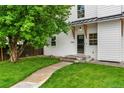 Charming two-story home with a lush lawn, a walkway to the front door, and a beautiful shade tree at 13483 Alcott Way, Broomfield, CO 80020