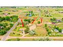 Stunning aerial view of the property showcasing the main house, barn, and Airbnb with lush green landscaping at 5557 Aspen Ave, Erie, CO 80516