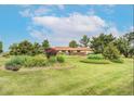 Beautifully landscaped front yard with lush greenery surrounding the charming exterior of the home at 5557 Aspen Ave, Erie, CO 80516