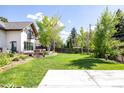 Expansive backyard showcasing a lush lawn, mature trees, and a patio area perfect for entertaining at 3445 S Clermont St, Denver, CO 80222