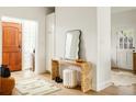 Chic entryway featuring a modern mirror, stylish console table, and a decorative stool, offering a welcoming and fashionable entrance at 3445 S Clermont St, Denver, CO 80222