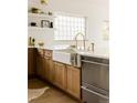 Modern kitchen with farmhouse sink, white countertops, and stainless steel appliances at 3445 S Clermont St, Denver, CO 80222