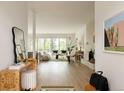 Sun-filled living room with hardwood floors, large windows, and open floor plan at 3445 S Clermont St, Denver, CO 80222