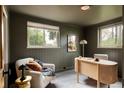 Cozy home office with natural light, green walls, built-in desk, and comfortable seating at 3445 S Clermont St, Denver, CO 80222