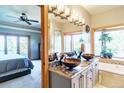 Bathroom featuring a vessel sink, a soaking tub, and a window with natural light and a view of trees at 1120 Brenthaven Ct, Monument, CO 80132