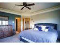 Comfortable bedroom with a ceiling fan, neutral walls, and carpet flooring, offering a cozy retreat at 1120 Brenthaven Ct, Monument, CO 80132