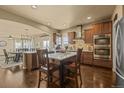 Modern kitchen features stainless steel appliances and dark wood cabinetry at 19814 Lindenmere Dr, Monument, CO 80132