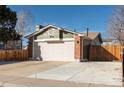 Charming home featuring a two-car garage and a well-maintained lawn at 14991 E Elk Pl, Denver, CO 80239