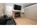 Inviting living room with a cozy fireplace and neutral color palette at 14991 E Elk Pl, Denver, CO 80239