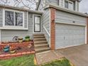 The exterior features a welcoming entrance with a gray door, brick accents, and landscaped details at 378 Benton St, Castle Rock, CO 80104