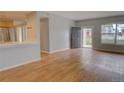 Bright, open living area with hardwood flooring and a kitchen view, creating a welcoming and connected living space at 2809 Syracuse Ct # 129, Denver, CO 80238