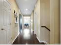 Bright hallway features a barn door, wood floors, and staircase at 26143 E Fremont Pl, Aurora, CO 80016