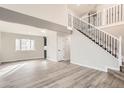Bright, open-concept living room featuring hardwood floors and a modern staircase with iron railings at 2358 Dogwood Cir, Louisville, CO 80027