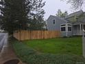 Charming home featuring a fenced-in yard and lush green landscaping for privacy and curb appeal at 2358 Dogwood Cir, Louisville, CO 80027