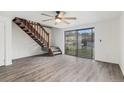 Bright living room with wood floors, ceiling fan, and sliding glass door to backyard at 1514 S Ouray Cir # B, Aurora, CO 80017