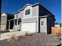 Charming two-story home with gray siding and a two-car garage, plus low maintenance front yard at 2351 Monte Vista St, Fort Lupton, CO 80621