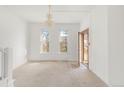 Bright living room featuring an open doorway and decorative chandelier at 3901 Alcott St, Denver, CO 80211