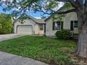 View of the house with a tree on the right and a lawn in the foreground at 16094 E Exposition Dr, Aurora, CO 80017