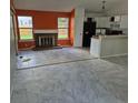 Bright living room featuring fireplace and tile flooring that connects to the kitchen at 16094 E Exposition Dr, Aurora, CO 80017