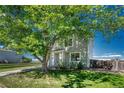 Charming two-story home with mature trees providing shade and curb appeal at 1353 Mallard Ln, Brighton, CO 80601