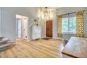 Bright entryway with a view of the front door, stairs, and a console table with a decorative mirror at 5532 S Valdai Way, Aurora, CO 80015